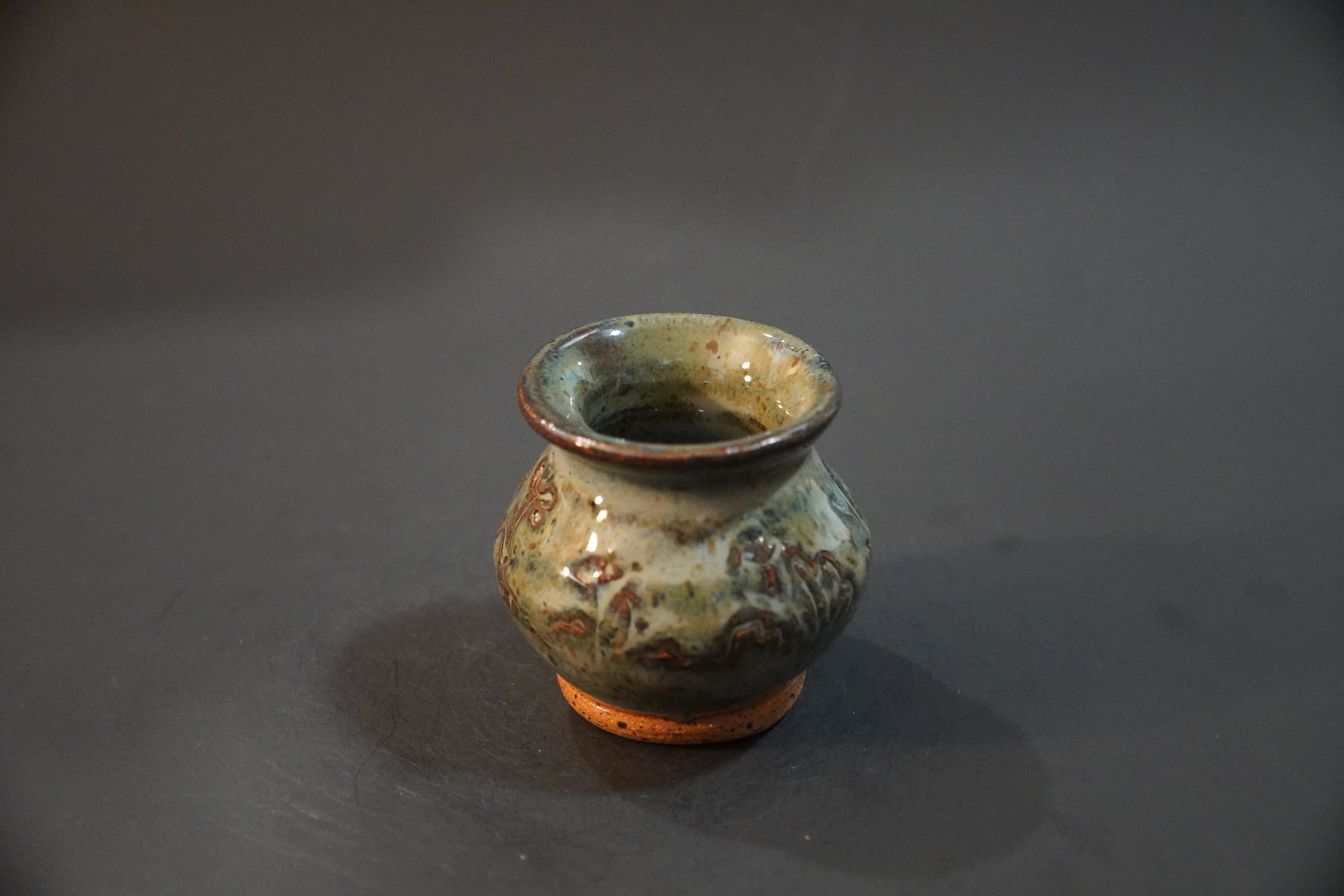 Small ceramic vase with denim glaze over subtle floral carvings